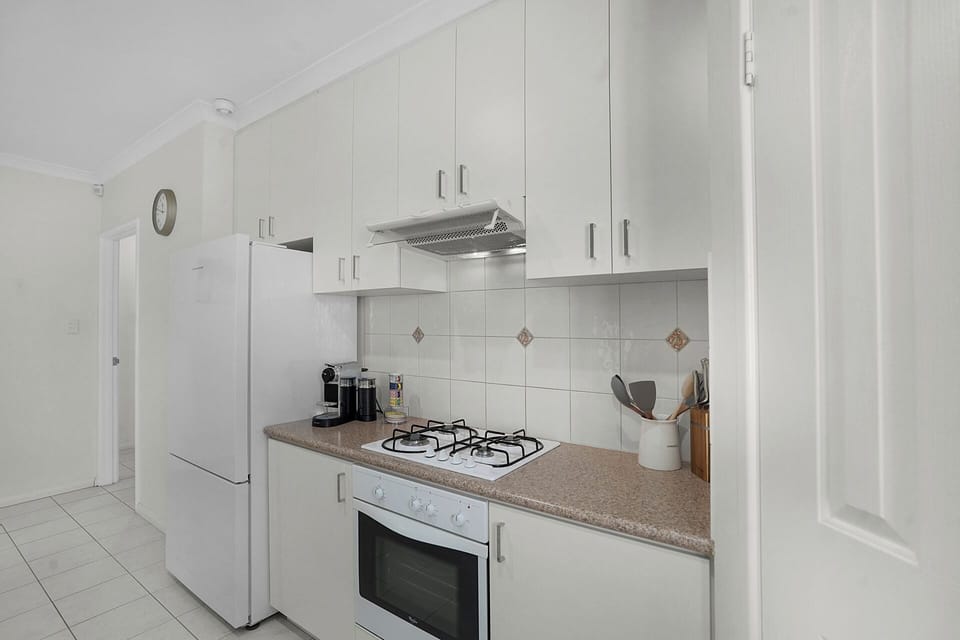 Bright, fully equipped kitchen with modern appliances and ample storage.