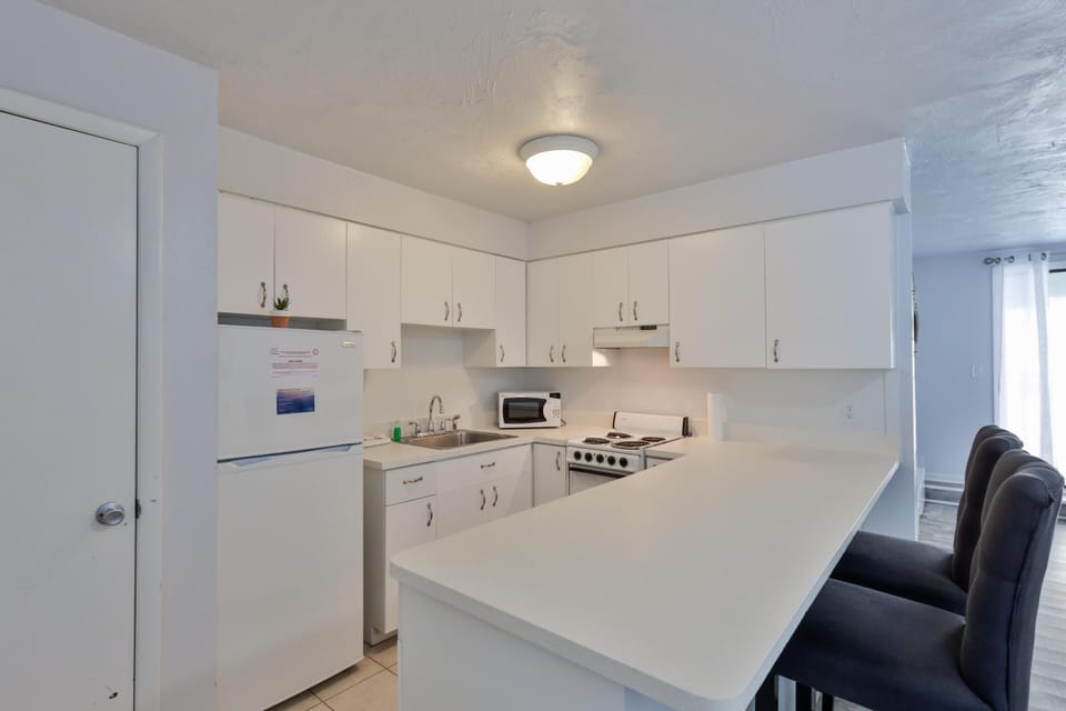 Bright, modern kitchen with spacious breakfast bar seating