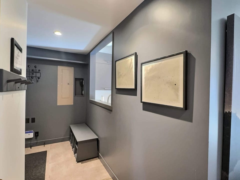 【Entry & Living】Front-door view into the open-concept space — condo runs long and light