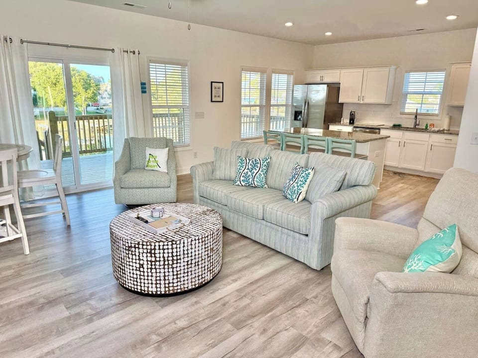Get cozy while you relax in this living room with a fireplace and water view. Sofa bed features a Queen mattress. 