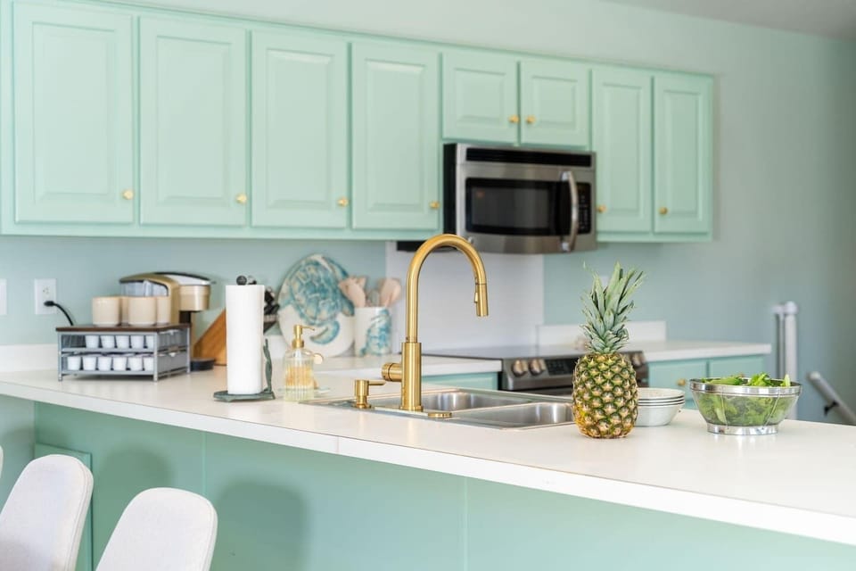 This thoughtfully equipped kitchen has everything needed for a relaxed beach stay, featuring stainless steel appliances, a large island, and generous counter space for cooking and gathering. It’s fully stocked with essentials including a Keurig coffe
