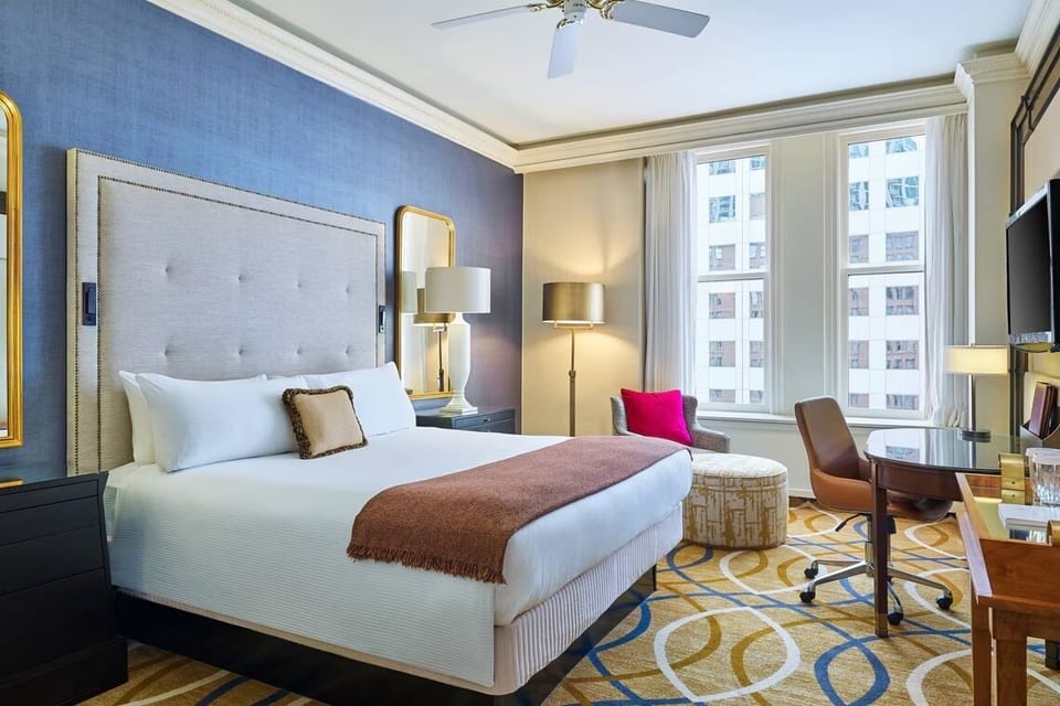 Unwind in a serene king bed with city views.
