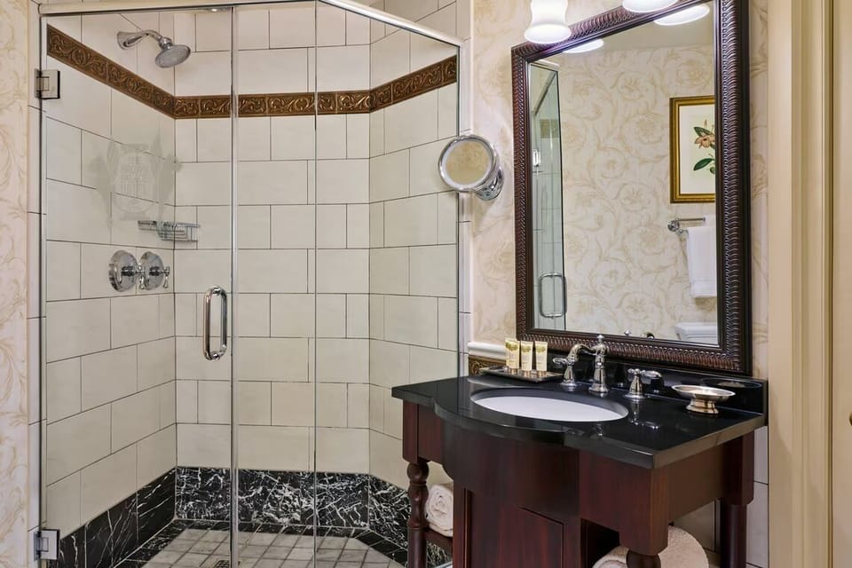 Refresh in a sparkling glass shower and polished vanity.