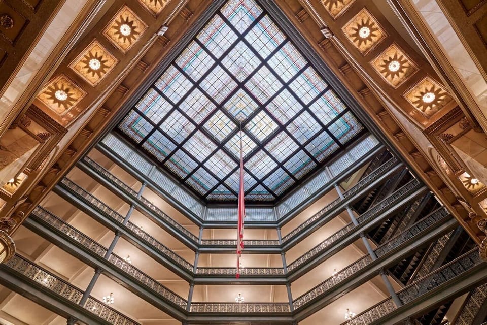 Look up and bask beneath the dazzling stained-glass skylight.