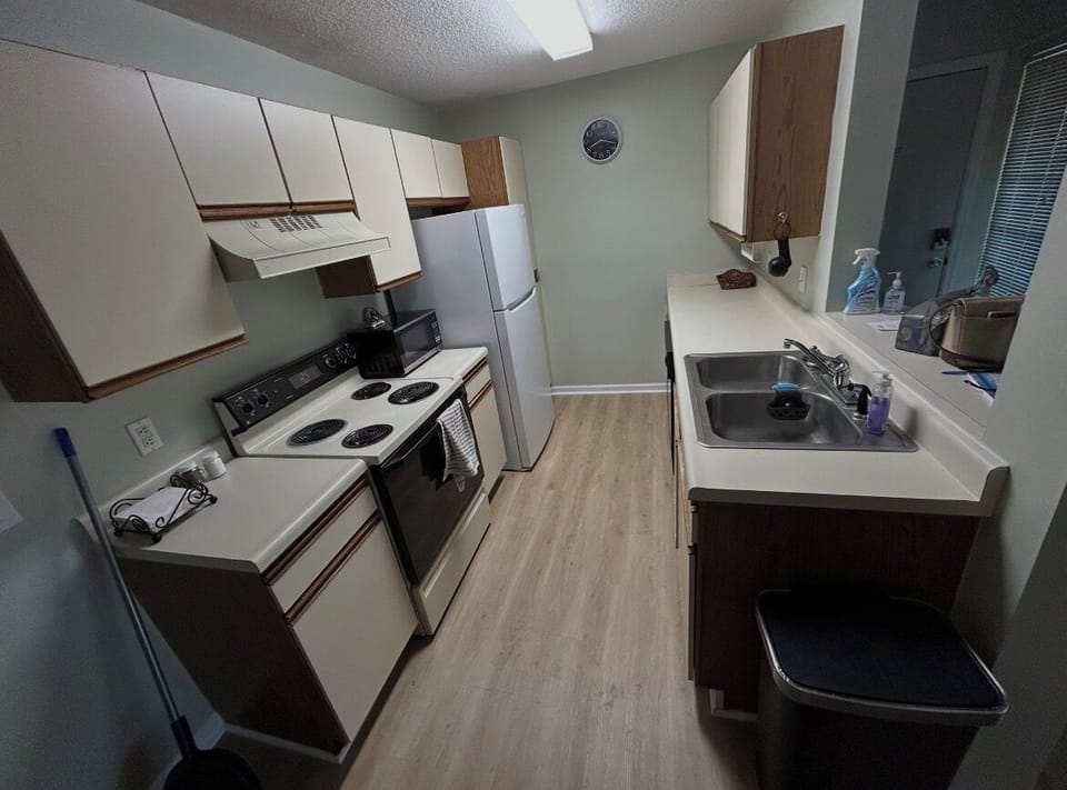 Full stocked kitchen. Plates, glasses, utensils, pots, pans. 