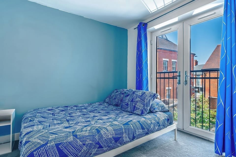 - Second bedroom with balcony style window   - Comfortable bedding and natural sunlight   - Ideal for couples or family accommodations  