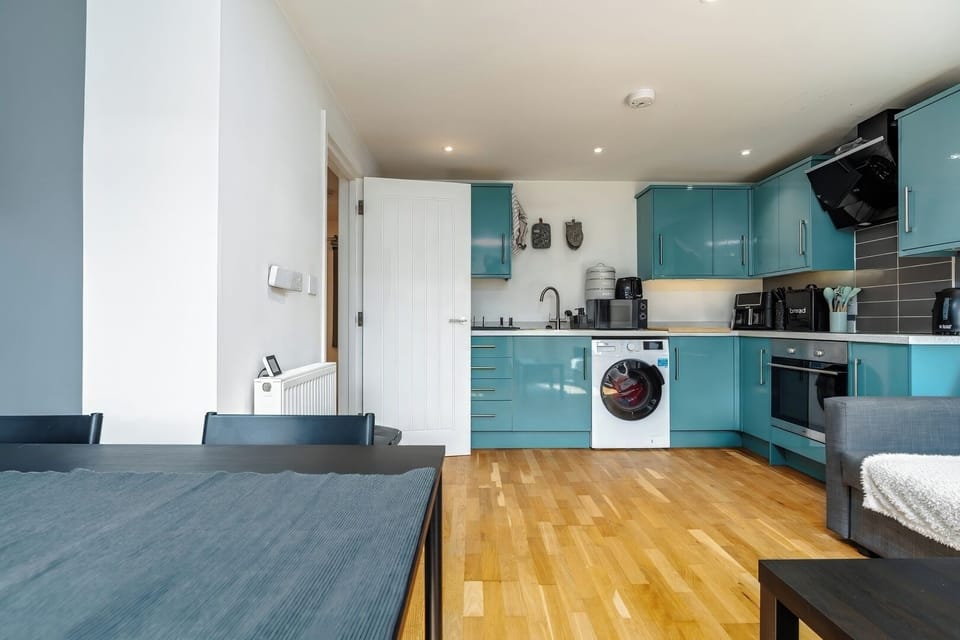 - Fully equipped kitchen with modern appliances   - Washing machine for extended holiday stays   - Open layout with dining area convenience  