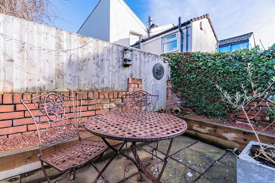 Outdoor patio with brick walls and greenery