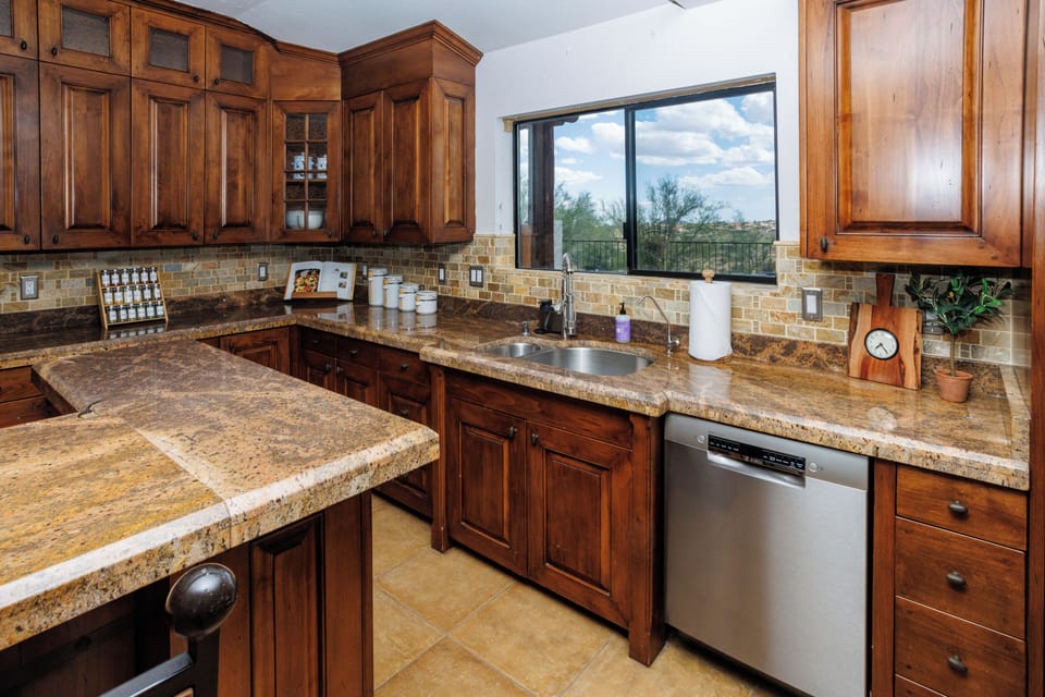 Completely stocked kitchen with modern appliances and a window view.