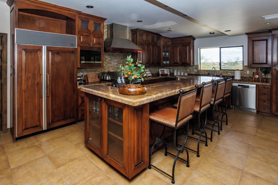 Contemporary kitchen has bar seating for morning coffee, quick meals and nightcaps.