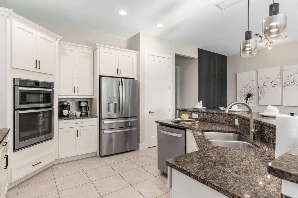 Modern kitchen w/ stainless appliances, sleek cabinetry & plenty of counter space