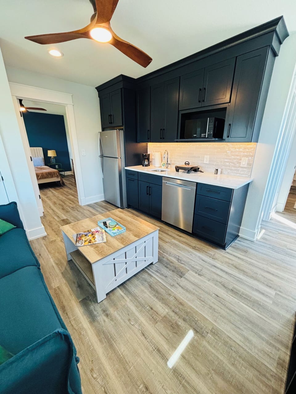 Sleek, modern kitchen featuring dark cabinetry and stainless steel appliances