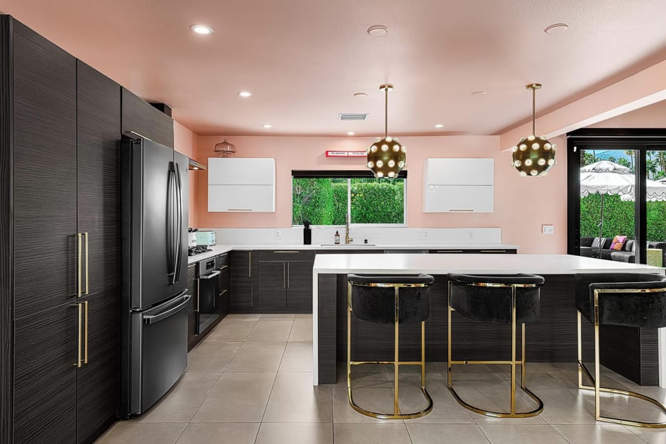 Gourmet kitchen with spectacular waterfall island and velvet bar stools