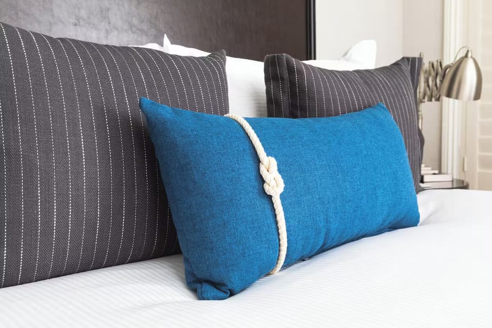 Sink into plush pillows with inviting, boutique-style blue accents.