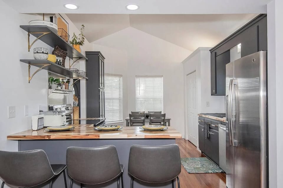 Whether you're enjoying a quick breakfast at the island or a sit-down dinner at the dining table, this space blends charm and functionality. Open shelving, warm lighting, and thoughtful touches make every meal feel special.