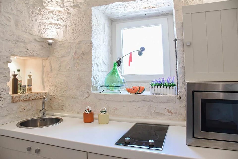 Wall, Kitchen, Interior Design, Countertop, Flooring, Kitchen Appliance, Lighting, Plumbing Fixture, Tap, Home