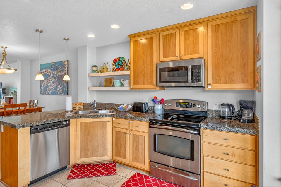 Your fully equipped kitchen features warm wood cabinets, granite countertops, and stainless steel appliances for all your culinary adventures.