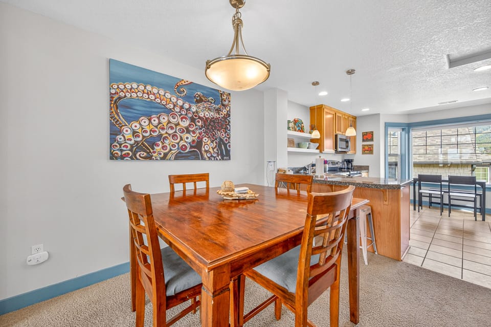 Gather around your elegant dining table for memorable meals, with a stunning octopus mural setting the perfect coastal ambiance for your getaway.
