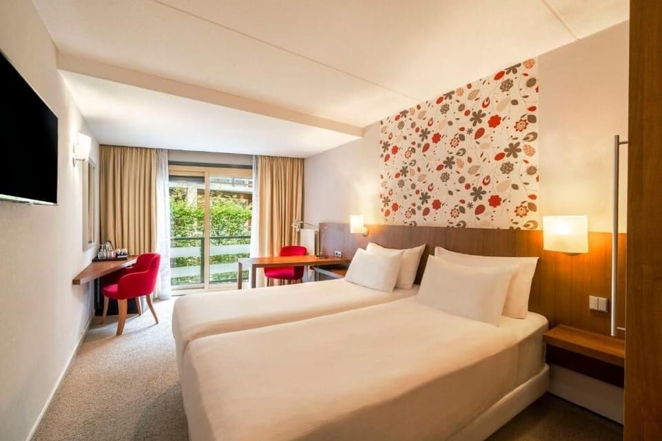 Unwind in crisp twin beds with soothing garden views.