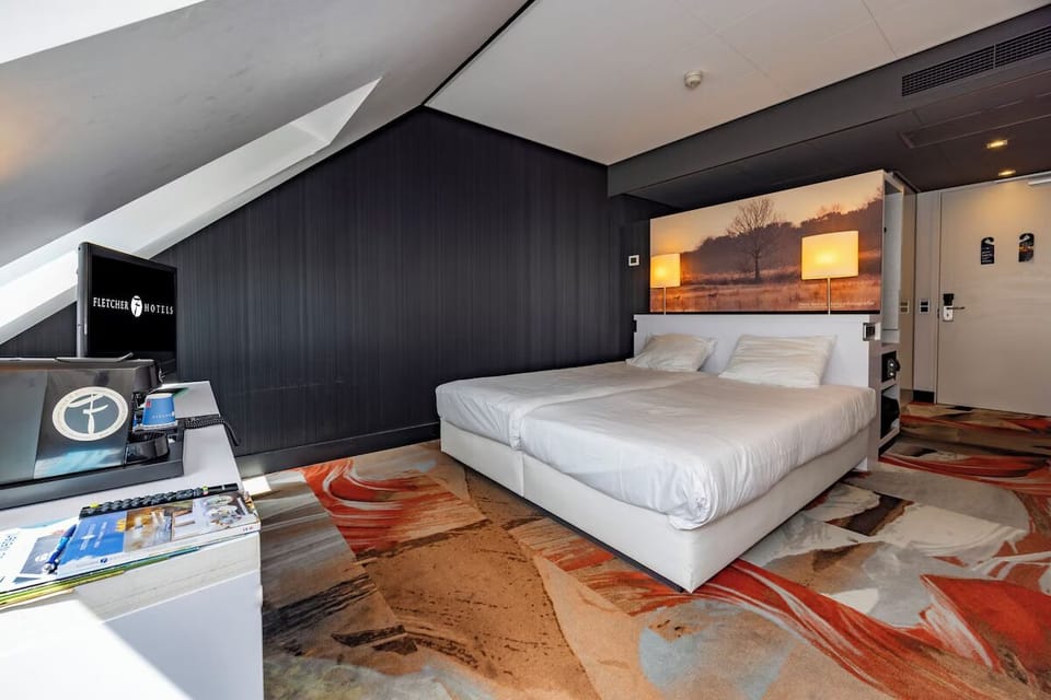 Unwind in a stylish room with crisp linens and warm light.