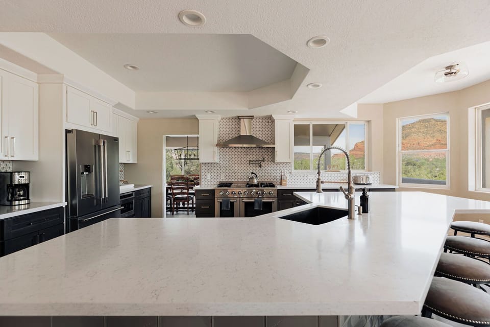 Your gourmet kitchen features stunning quartz countertops, premium appliances, and breathtaking mountain views through expansive windows.