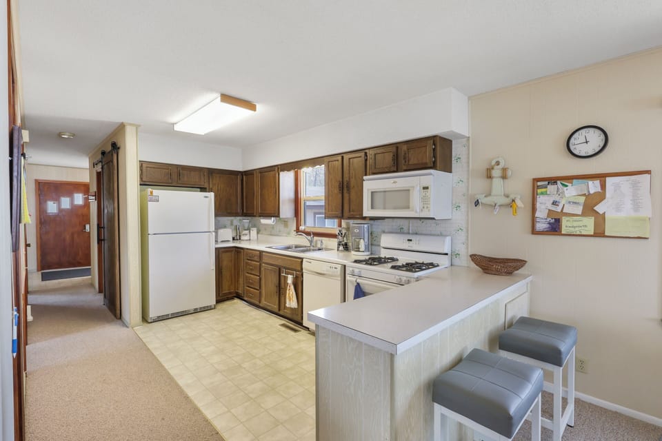 Your fully equipped kitchen features everything you need for home-cooked meals, with a convenient breakfast bar perfect for morning coffee.