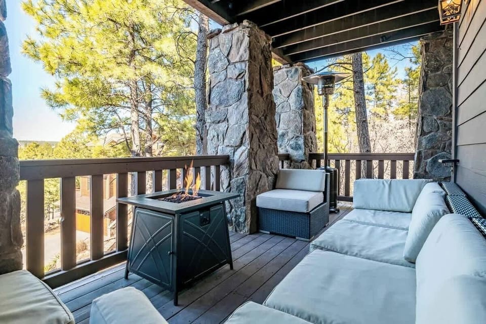Covered patio area located directly off of the kitchen with propane fire pit and heater--the perfect area to enjoy a beverage, the views and a sunset on a chili evening.  