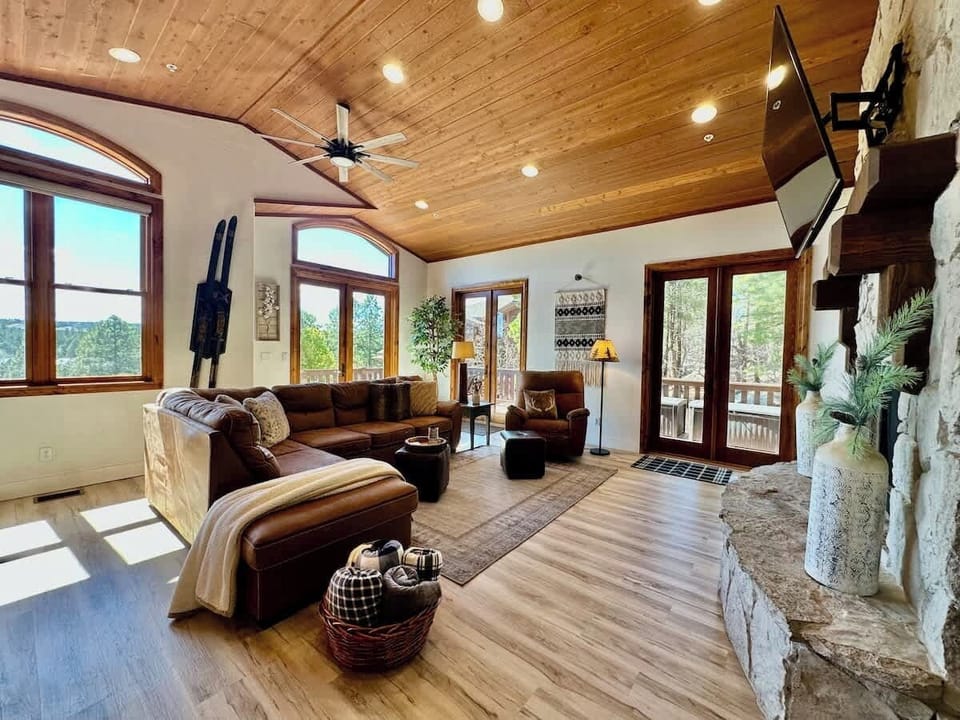 Plenty of comfortable seating in the second living room for the entire group;  Several french doors not only provide direct access to the wrap around deck, but also provide views of the surrounding pines and canyon.  