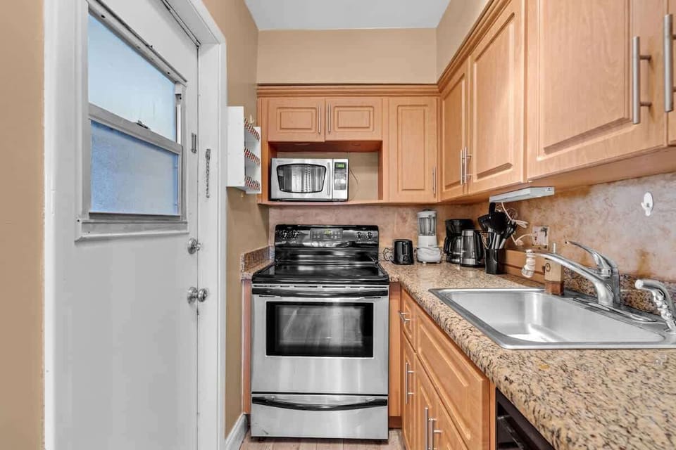 This stylish, remodeled kitchen blends sleek design with a practical layout for the ultimate beachfront sanctuary.