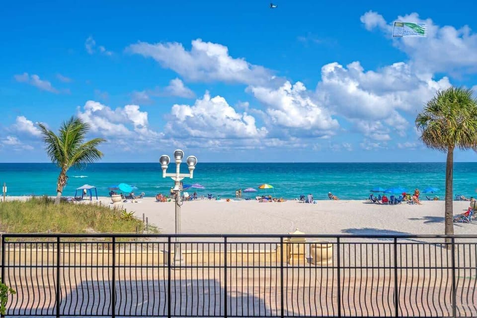 This is your actual view. Turquoise Atlantic waters, white sand, and swaying palms — all just steps away. Wake up to this every morning and walk to the beach in under a minute.