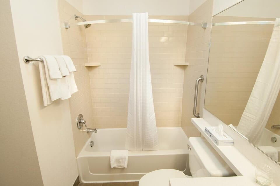 Refresh with a hot shower in a spotless, bright bath.