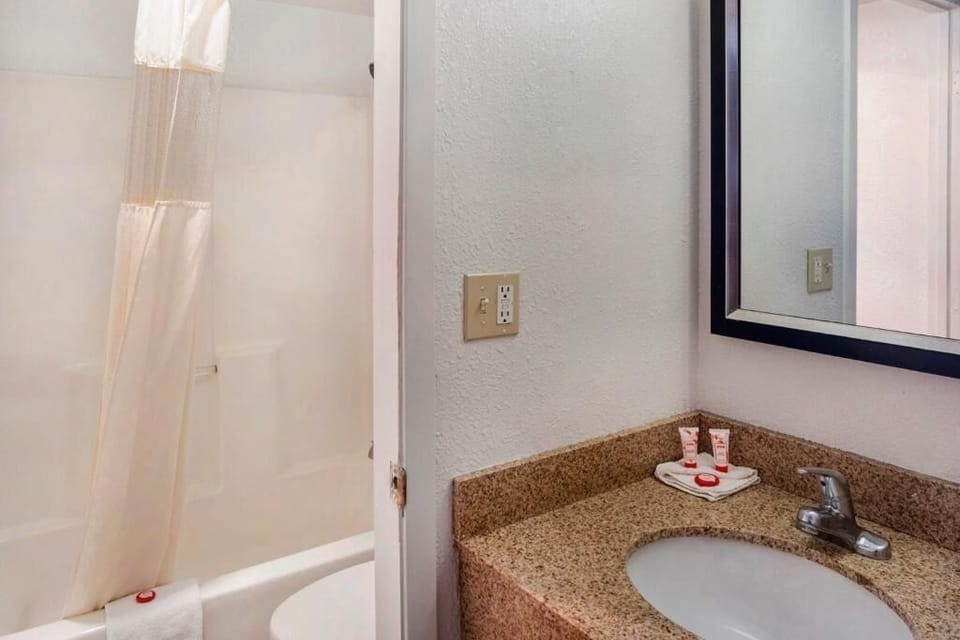 Step into a fresh bathroom with sink and shower nearby.