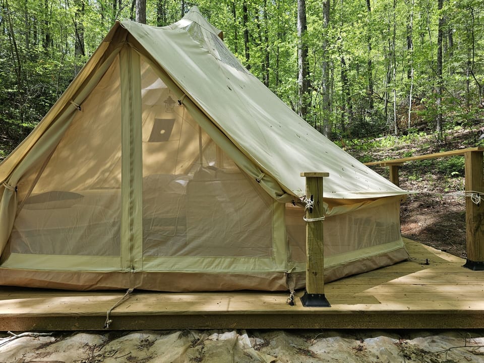 Roll-up sidewalls and screened panels invite fresh mountain air while keeping the space comfortable and connected to nature.