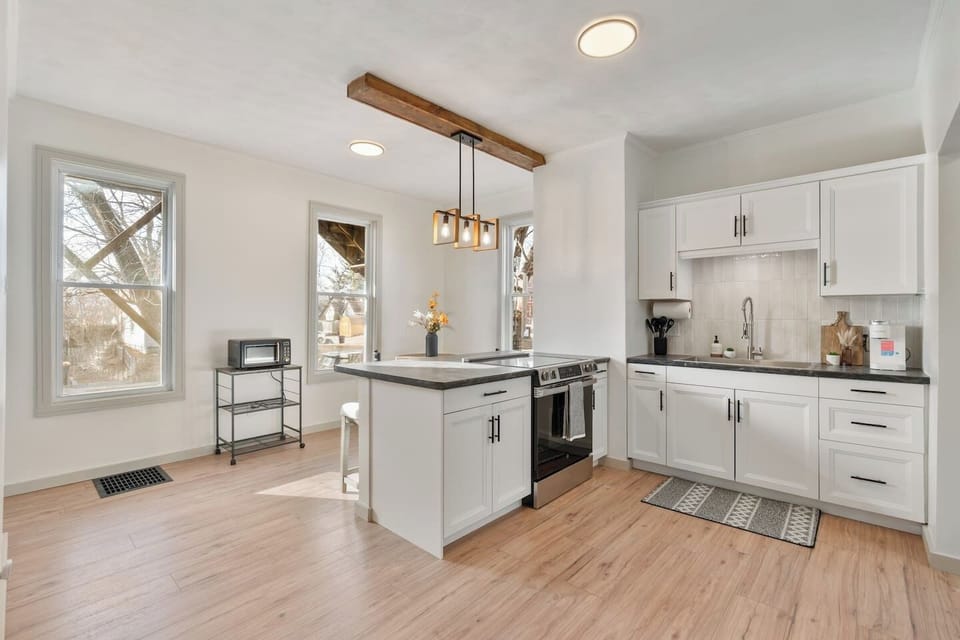 Full kitchen with a microwave, electric stove/oven and extra large sink. 