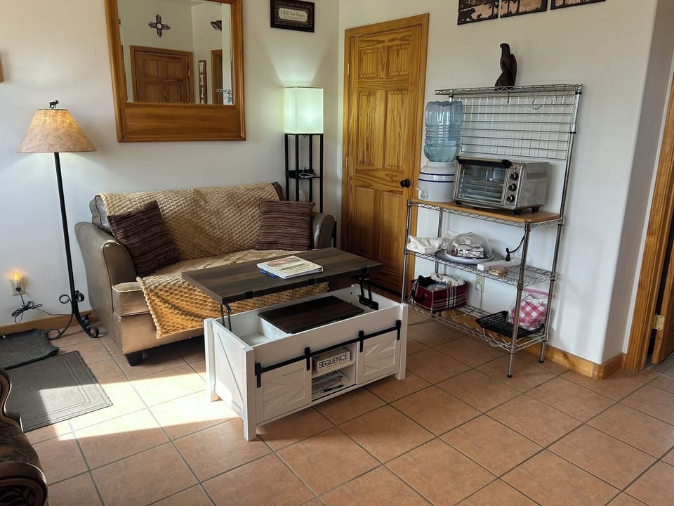 Flexible layout and cozy seating area; Brown couch was replaced by black couch.