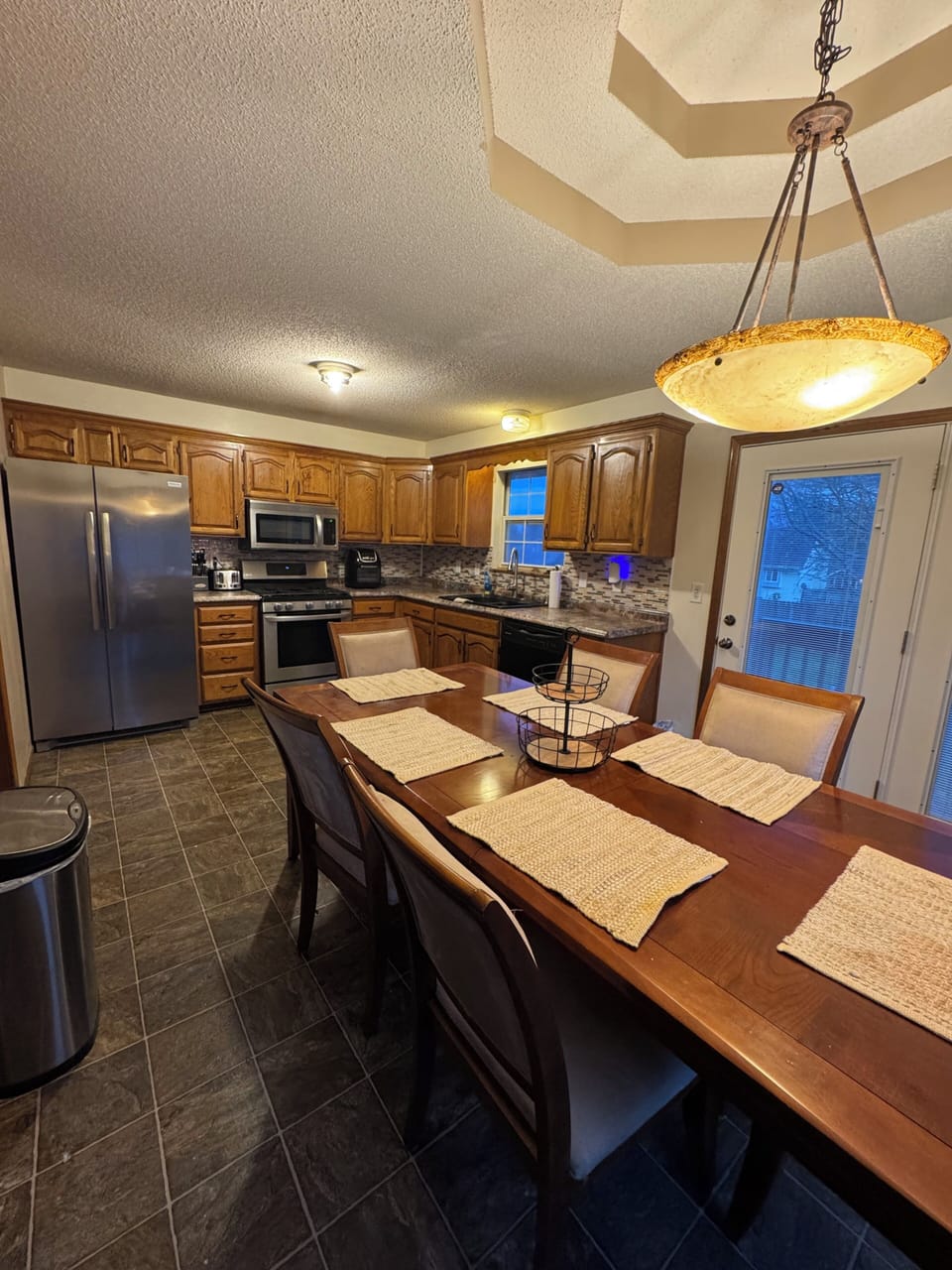 Large dining room table sits 6 people, right next to the open living room.