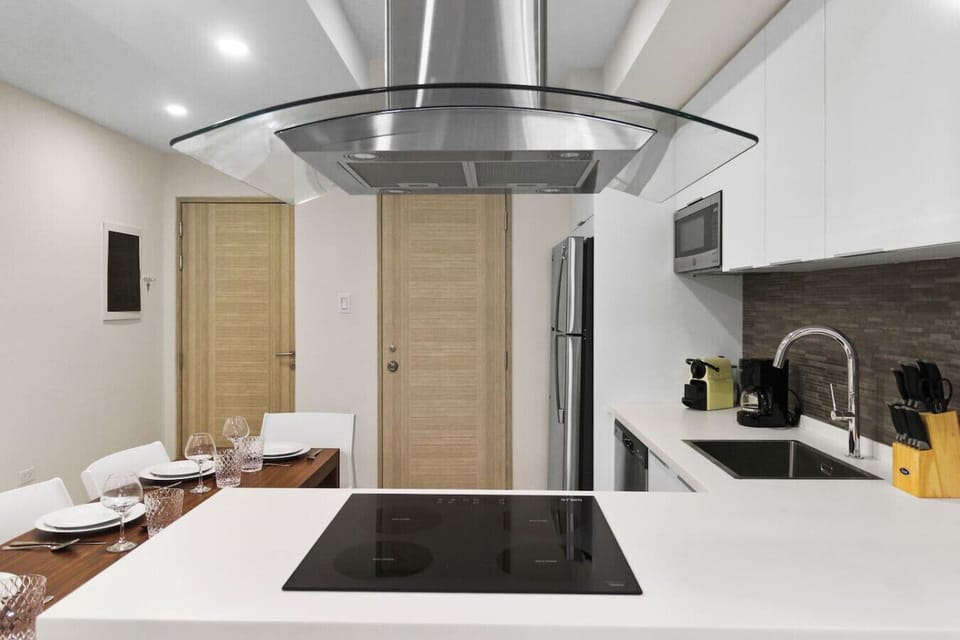 Cook and dine with ease in this sleek, fully equipped kitchen—perfect for home-style meals during your stay.