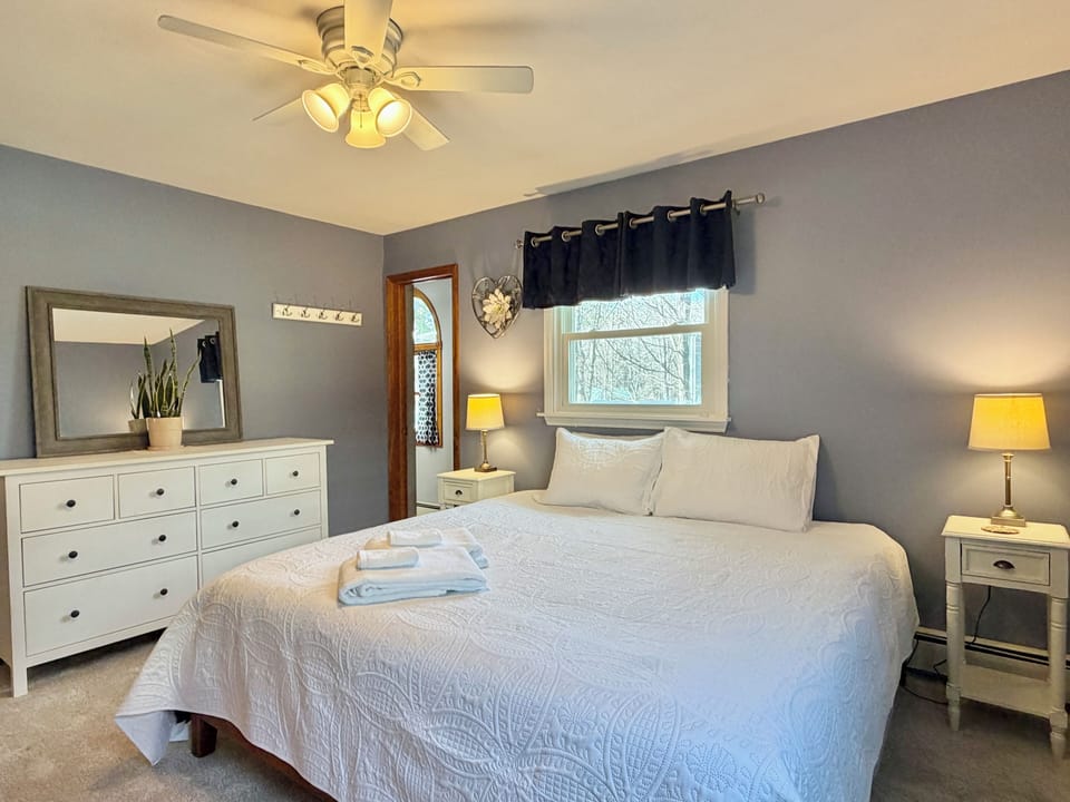 Spacious bedroom with dresser and natural light