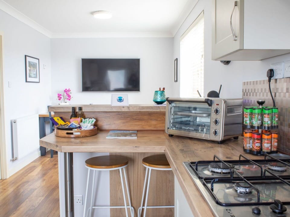 Furniture, Kitchen, Countertop, Kitchen Appliance, Interior Design, Major Appliance, Flooring, Cabinetry, Wood, Home Appliance