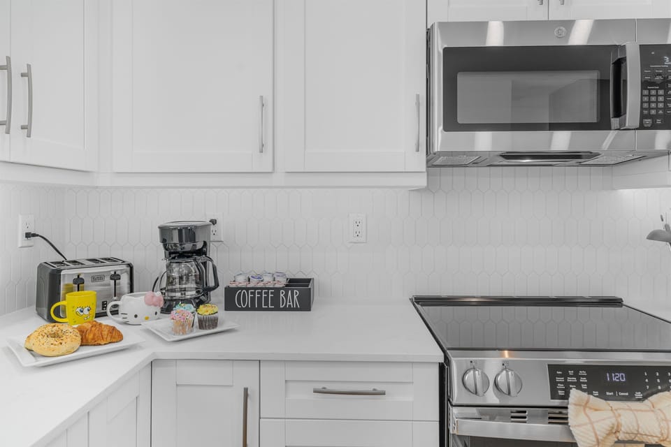 Fully equipped kitchen with stainless steel appliances and coffee station for your mornings.