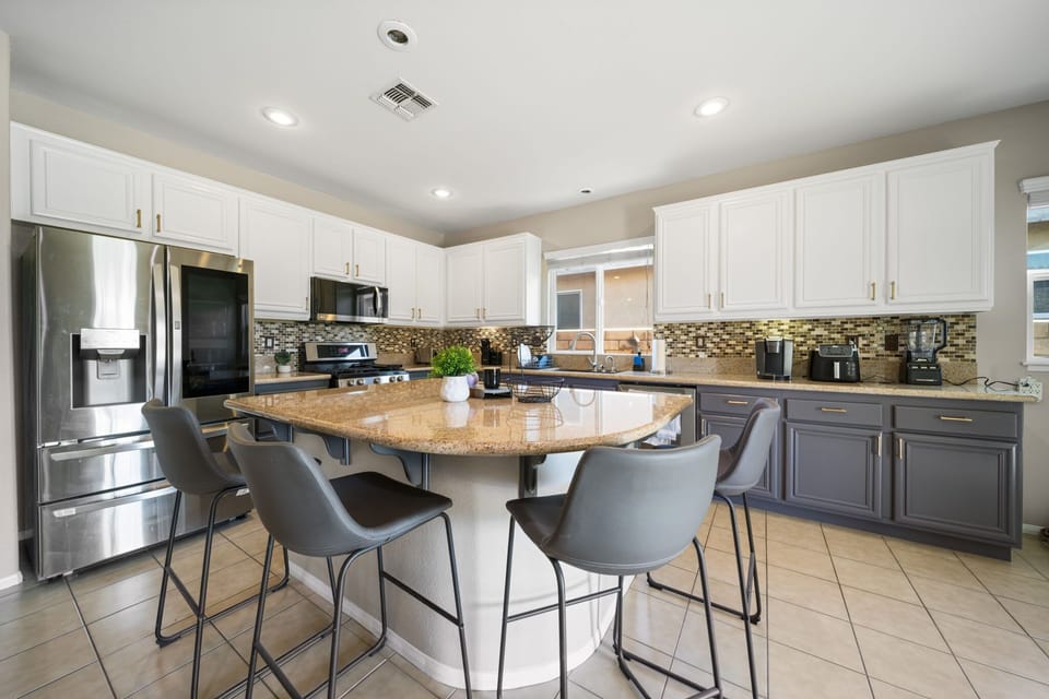 Bright and fully equipped kitchen with plenty of counter space and seating for everyone.