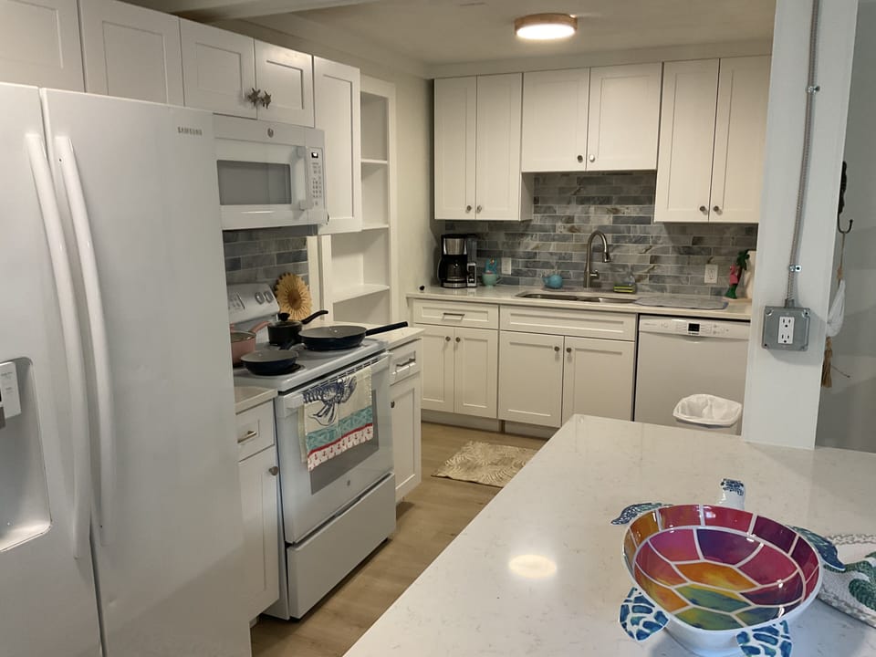Fully stocked kitchen with Frig, stove, and microwave