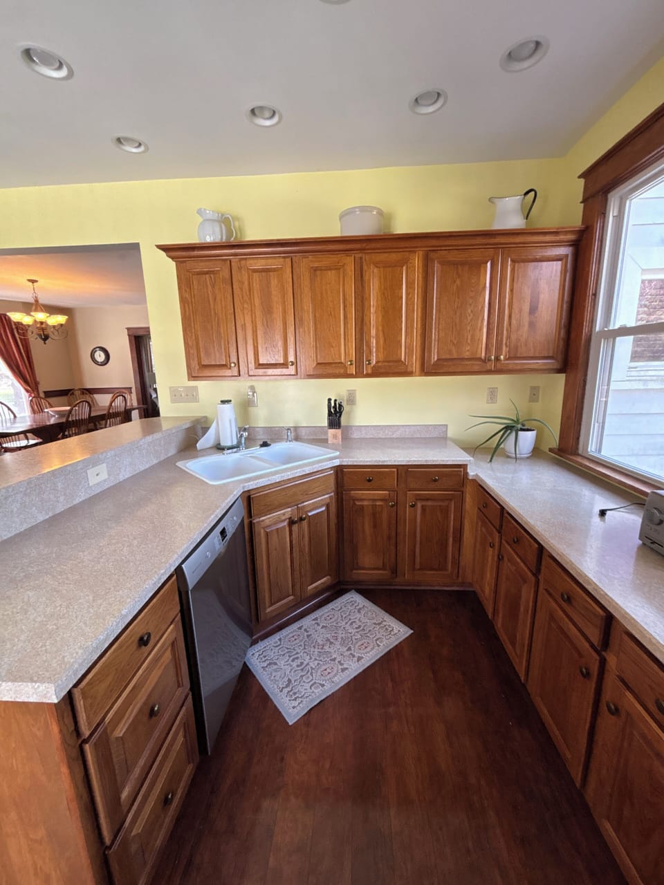 Bright U-shaped kitchen with ample counters and dining pass-through