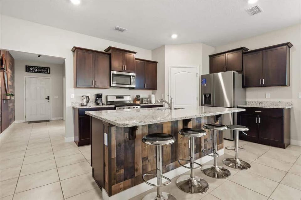 Gather in this stylish, fully equipped kitchen with stainless steel appliances, spacious counters, and island seating. Perfect for family meals, morning coffee, or evening chats, it’s designed for comfort and connection.