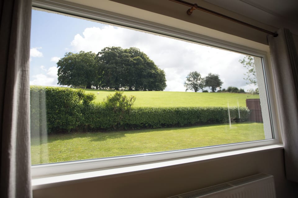 Amazing view from Living Room at Wall and Lakes Cottage, hedges, lawn and fields