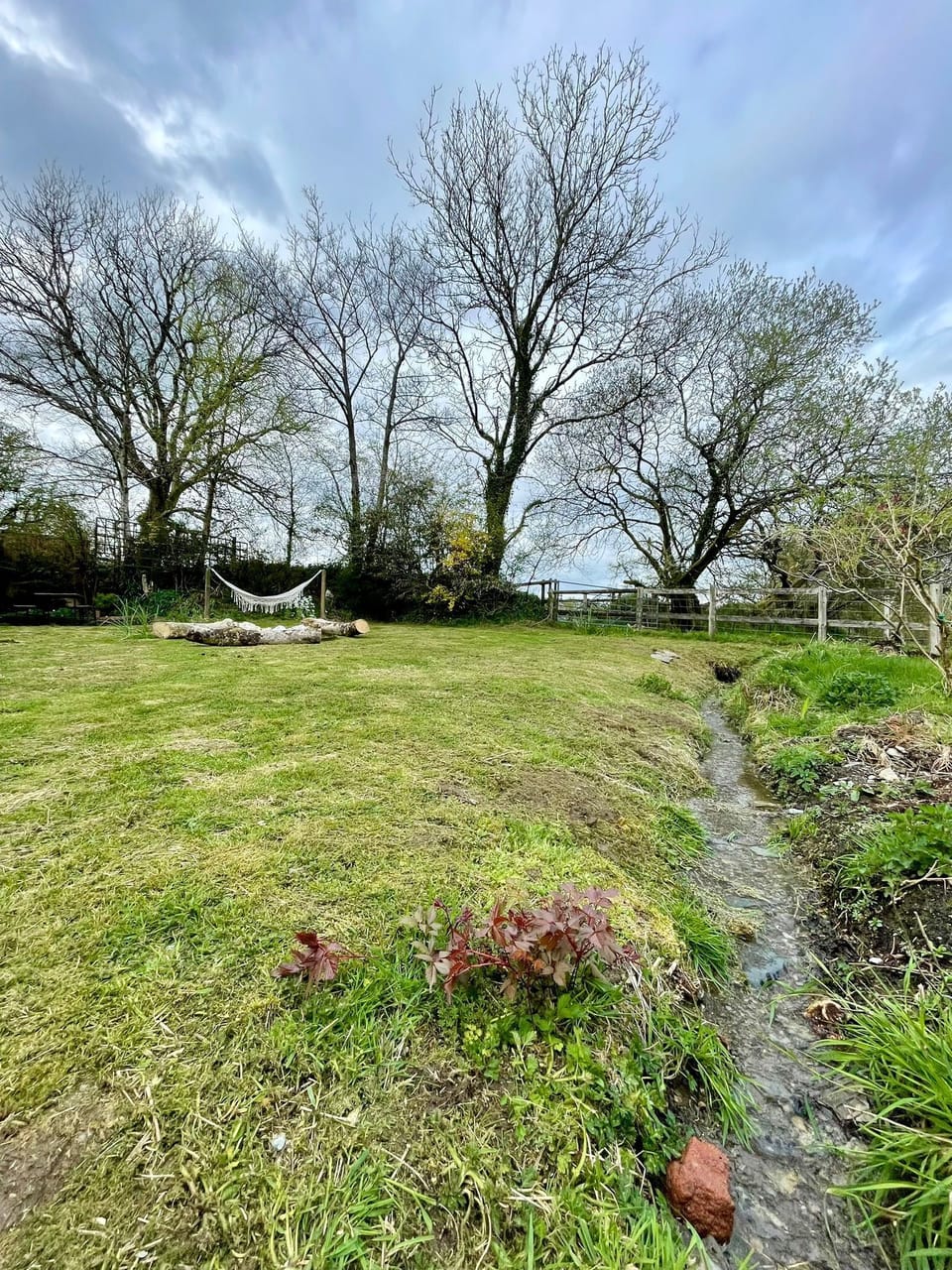 Enclosed private garden with stream flowing 