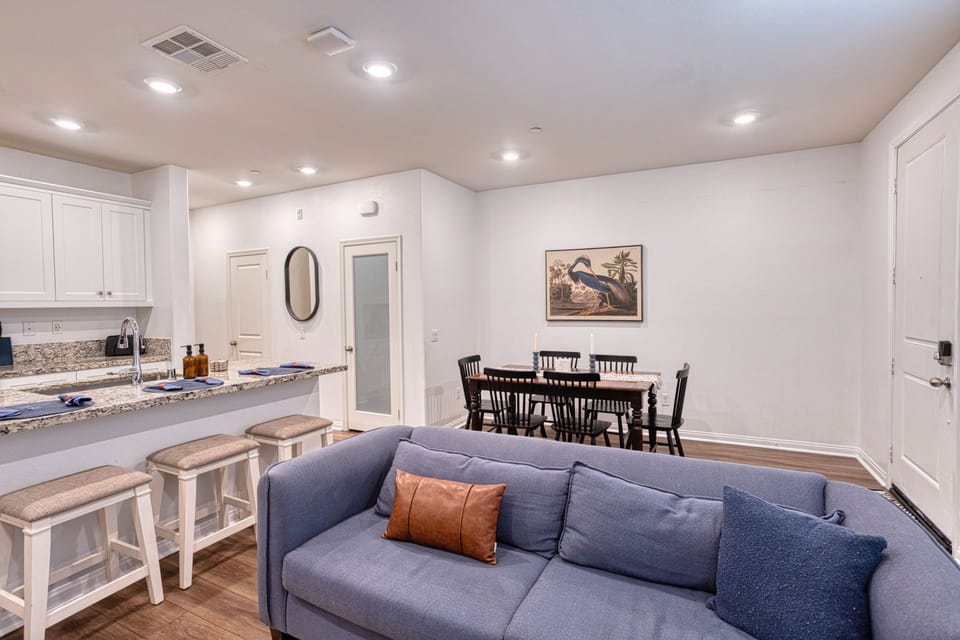 Open-concept layout connecting the cozy living area, dining, and kitchen island
