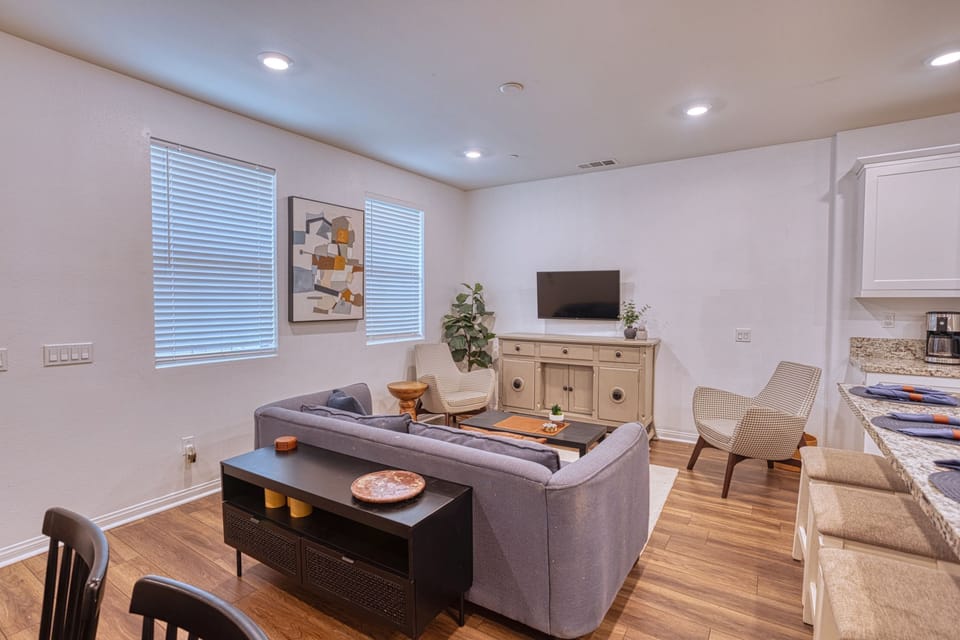Relax in this stylish living area featuring a smart TV and comfortable seating