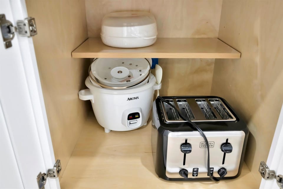 Rice cooker and toaster in kitchen cabinet