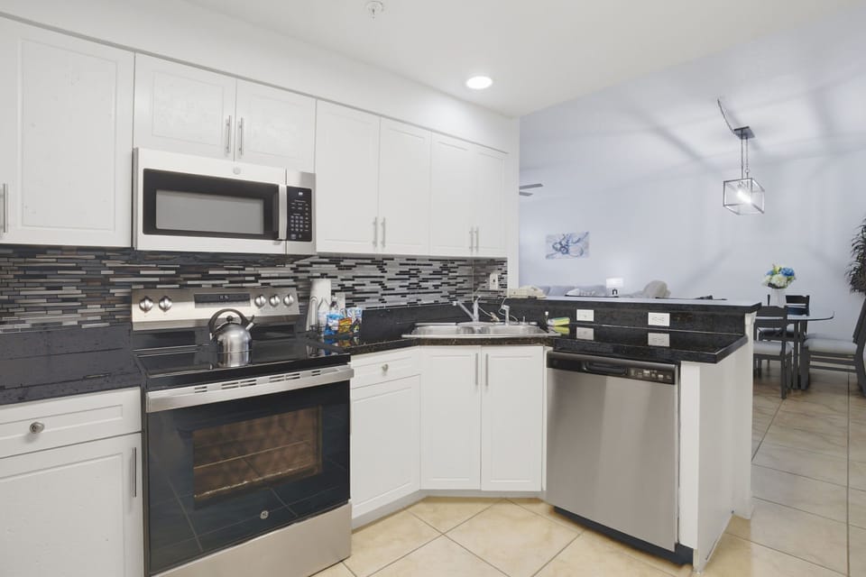 Spacious kitchen with ample counter space and bar seating for added convenience.